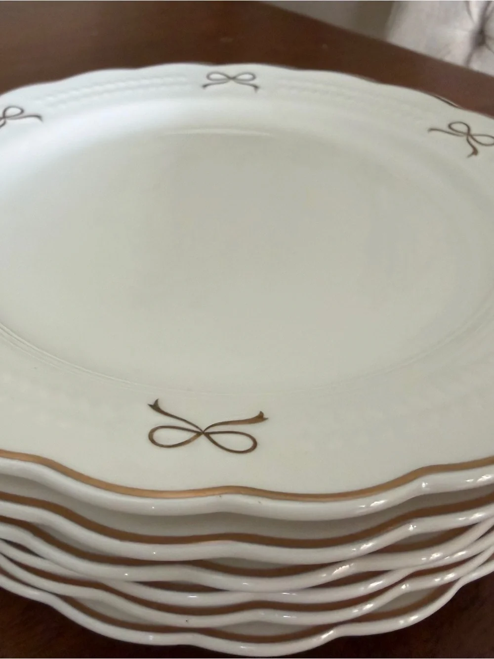 Set of White Scalloped Dinner Plates with Gold Bow Details
